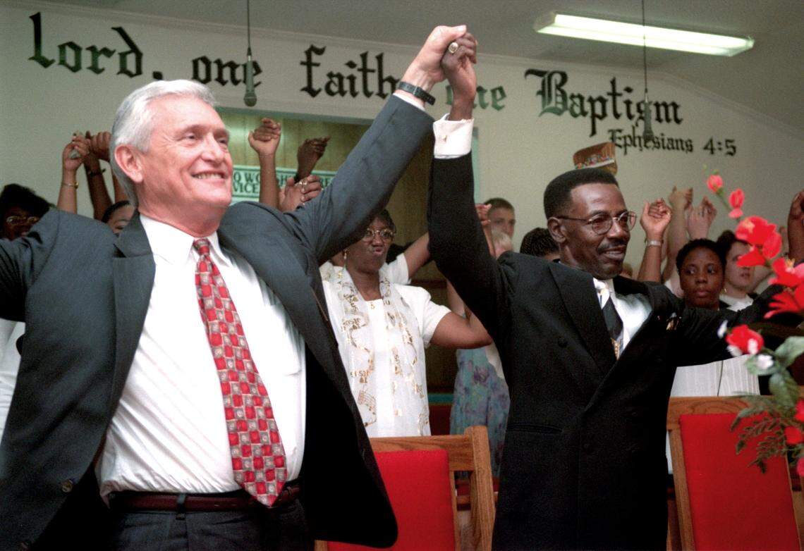 Columbia lawyer Tom Turnipseed and the Rev. Jonathan Mouzon celebrate with the congregation of Macedonia Baptist Church Sunday after the church was awarded $37.8 million Friday in a civil trial against the Ku Klux Klan and its South Carolina leader, Grand Dragon Horace King. ‘If you feel like you’ve been blessed this morning, just lift your voice,’ Mouzon told the congregation.