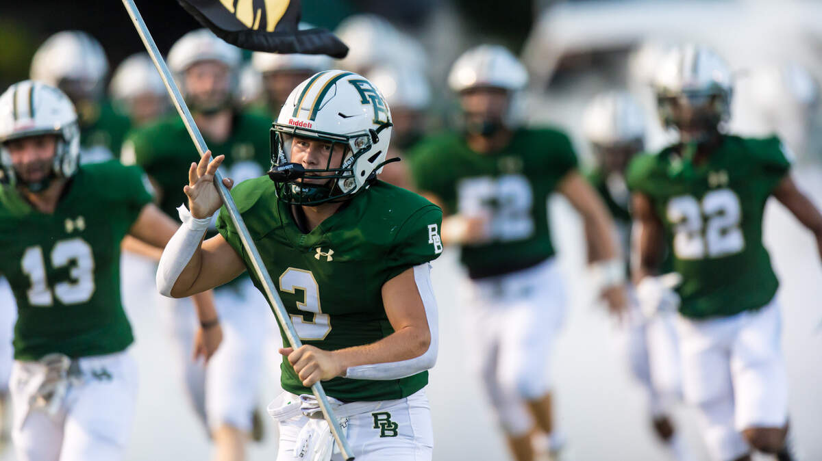 River Bluff Gators Gray Herring (3) leads his team onto the field before the game against the Irmo YellowJackets at River Bluff High School Friday, Sept. 2, 2022.