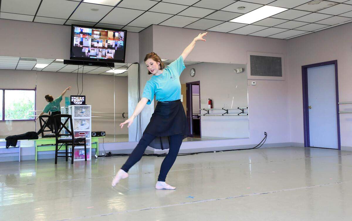 Carolina Douglas Bliss demonstrates a move to her dance students who are watching from their homes on a computer. Due to the coronavirus, Bliss and other teachers at South Carolina Christian Dance Theater in Irmo are connecting with their students through video, via the internet.