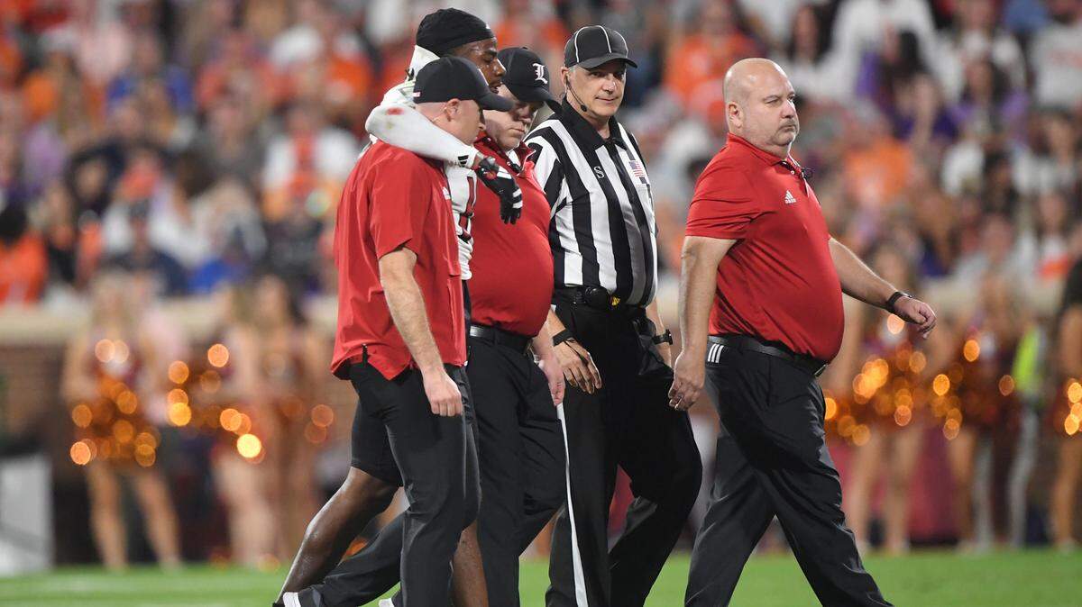 Nov 2, 2024; Clemson, South Carolina, USA; Louisville Cardinals defensive back Benjamin Perry (10) is assisted off the field by staff during first quarter against the Clemson Tigers at Memorial Stadium.