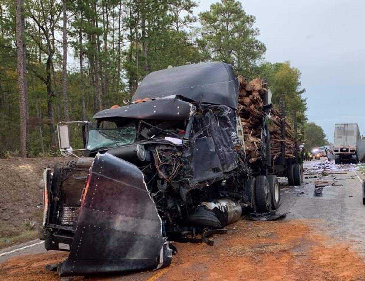 A truck hauling logs was one of two tractor trailers involved in a wreck with a passenger bus, Columbia police said.