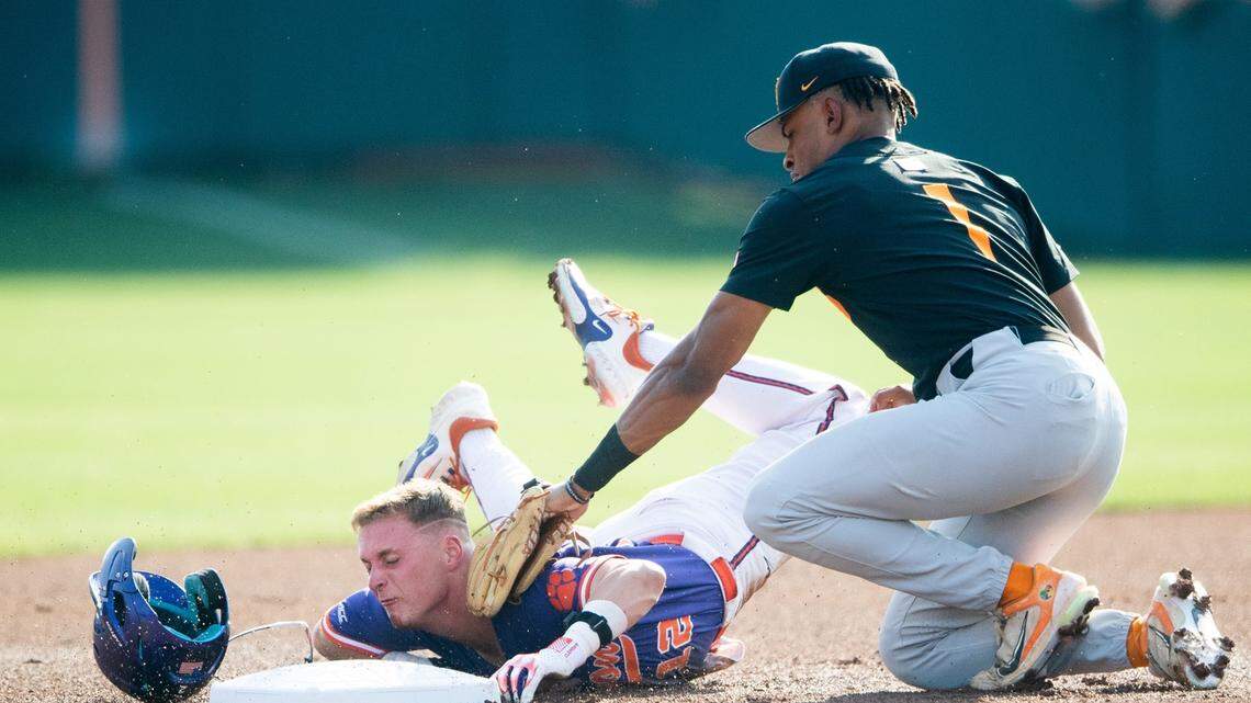 Tennessee infielder Christian Moore (1) tags Clemson’s Cooper Ingle (12) out at second base during a NCAA baseball regional held at Doug Kingsmore Stadium in Clemson, S.C., on Saturday, June 3, 2023.