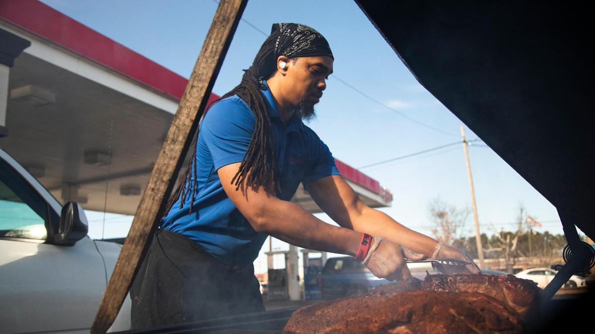 Chris Williams smokes brisket and pork at his restaurant, Roy’s Grille, located at a gas station in Lexington, South Carolina on Friday, January 7, 2022.