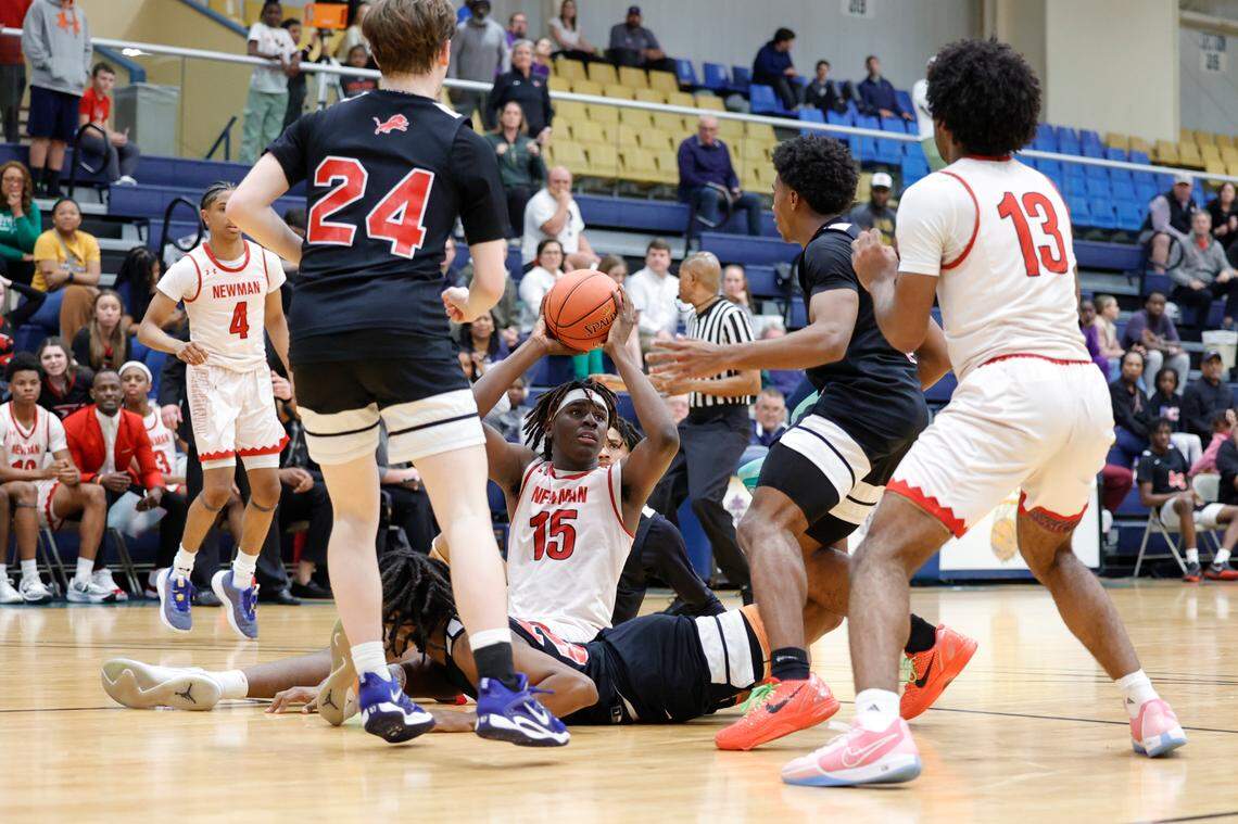 Cardinal Newman’s Elton Smith Jr. (15) snags a loose ball from Augusta Christian’s Shelby Hughes (23) during the second half of action in the Class 4A SC Independent Schools Association championship at the Sumter Civic Center on Friday, Feb. 23, 2024