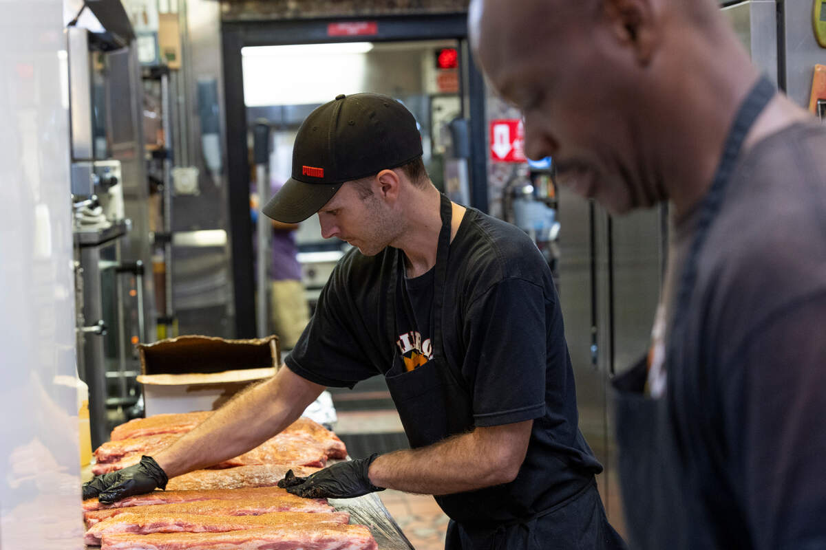 A secret blend of spices is rubbed into ribs at Railroad BBQ in Columbia, South Carolina on Thursday, September 15, 2022. Owner Kevin Gray says that workers are continuously smoking meats all day and night at the restaurant.