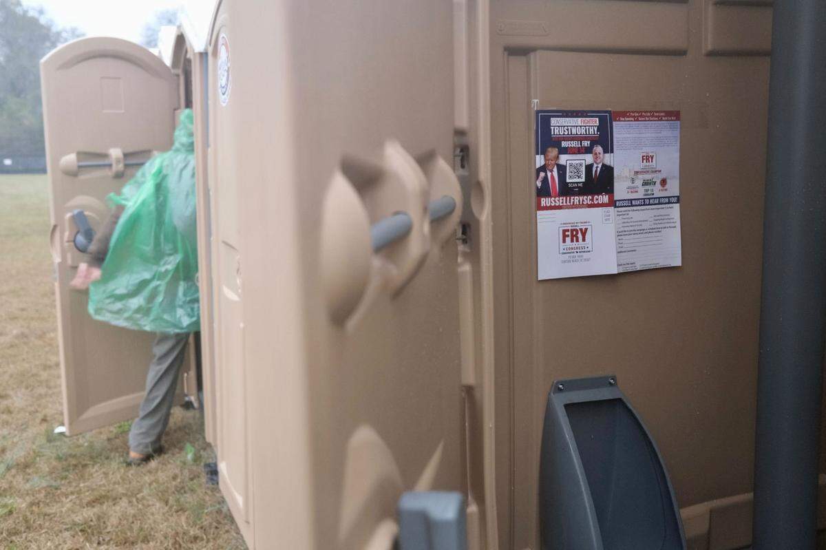 Campaign fliers for S.C. Rep. Russell Fry, who is running for the 7th Congressional District seat against incumbent Republican U.S. Rep. Tom Rice, R-Myrtle Beach, are posted on a port-a-potty at former President Donald Trump’s rally on Saturday, March 12, 2022, in Florence, S.C.