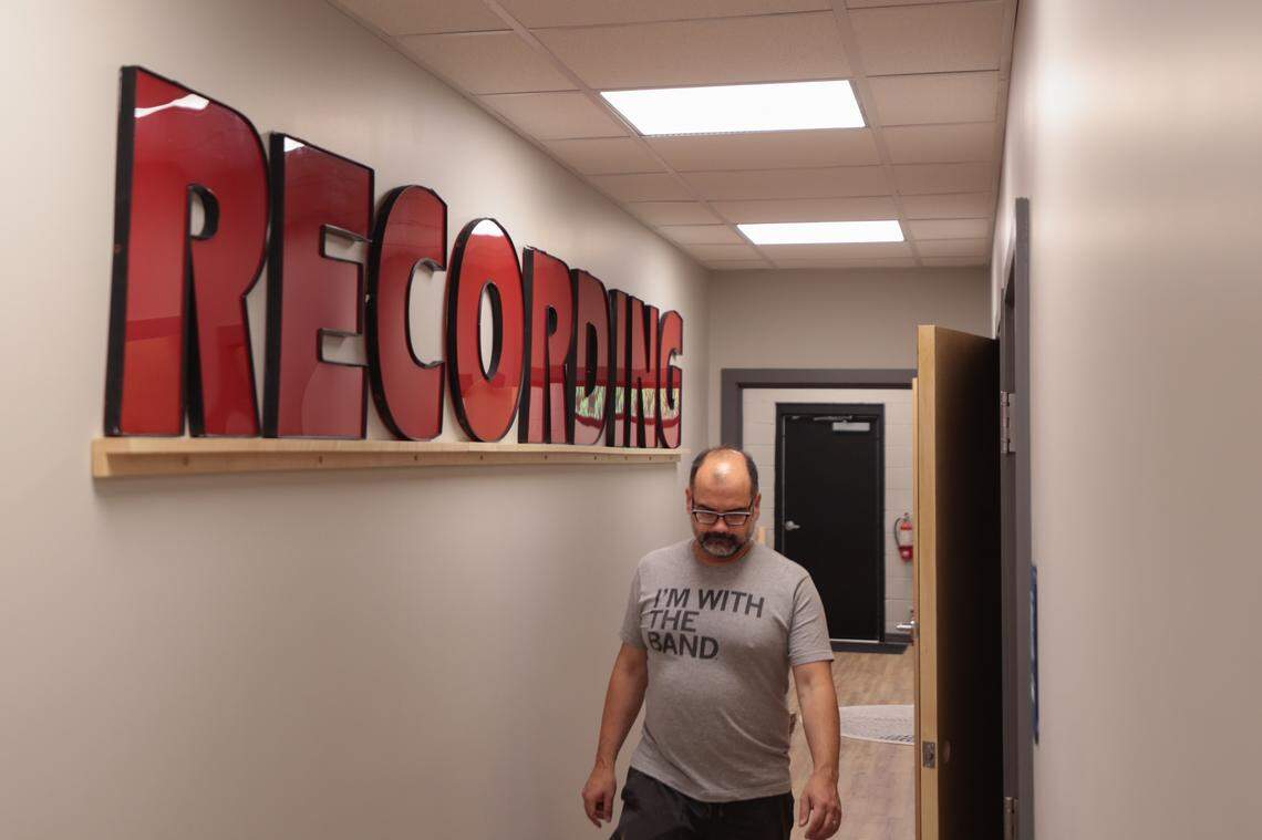 Philippe Herndon walks past the recording sign he salvaged from the Charlotte Sam Ash music store inside River Drive Creative in Columbia on Wednesday, June 18, 2025. The building houses Archer Avenue Studio and Caroline Guitar Company.