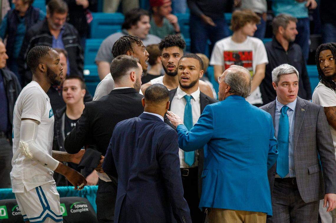 Coach Cliff Ellis tries to control Coastal players after an altercation in the last seconds of the game on Wednesday against South Carolina.