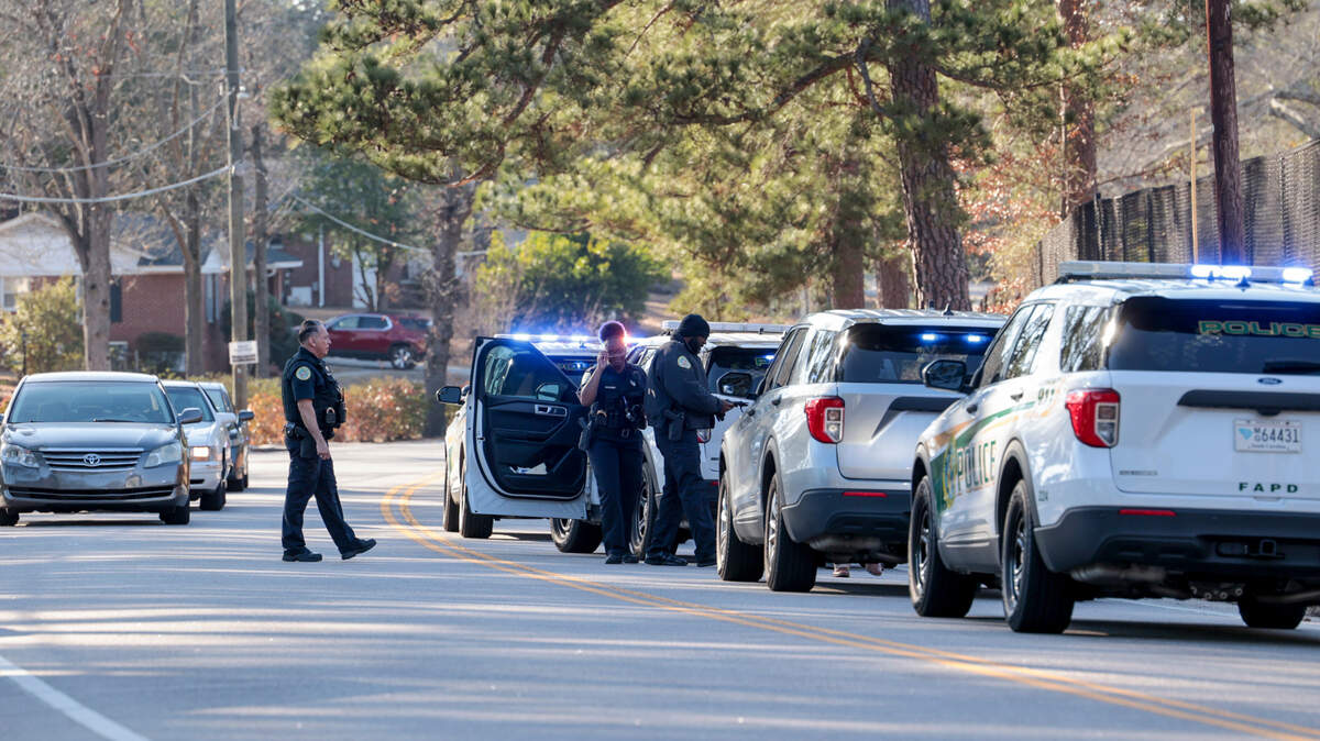 Law enforcement officials gather near Bradley Elementary school where Ty’ quan Kelly was apprehended on Monday, Feb. 3, 2025. Kelly is accused of shooting into a car with a woman and two children earlier in the day.