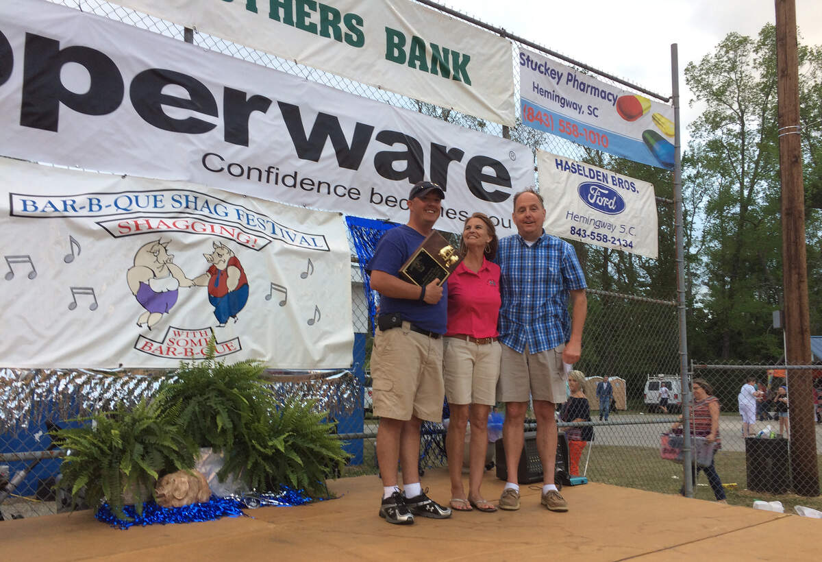 Marie Curtis, center, with Ryan Owens and Wayne Owens pose with the First Place trophy at the 30th Annual South Carolina BBQ Shag Festival in Hemingway, SC, April 14, 2018.
