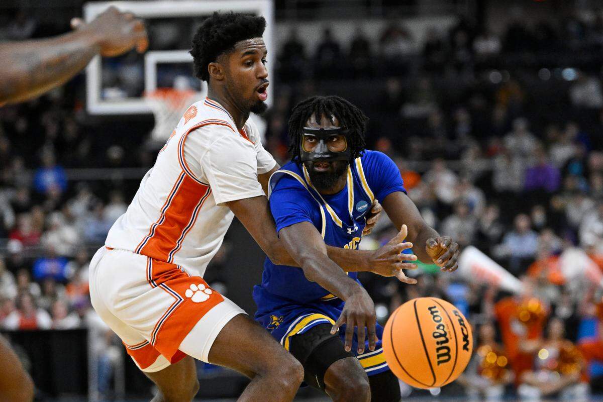Mar 20, 2025; Providence, RI, USA; McNeese State Cowboys guard Javohn Garcia (6) passes the ball against Clemson Tigers forward Chauncey Wiggins (7) during the second half at Amica Mutual Pavilion.