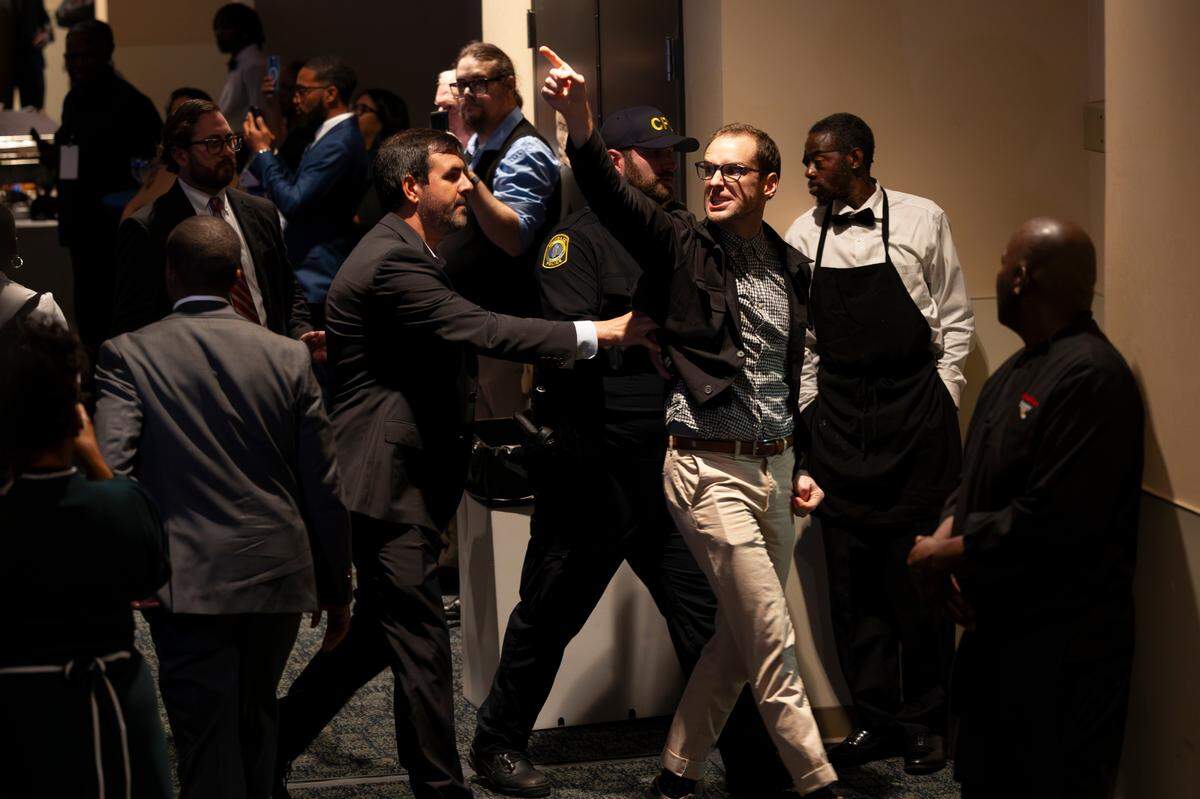 Police escort a person who disrupted President Joe Biden speaking during an appearance at the South Carolina Democratic Party’s First-in-the-Nation Celebration Dinner on Saturday, Jan. 27, 2024.