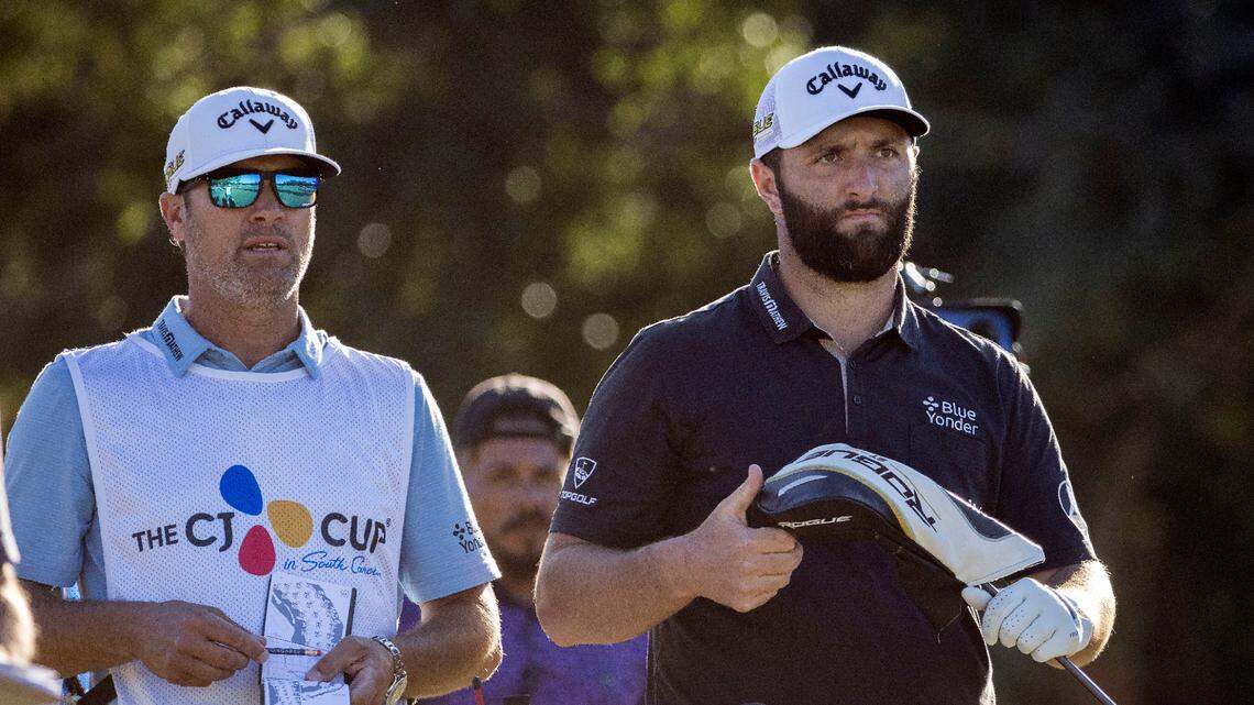 Jon Rahm, right, of Spain plans his shot with his caddie Adam Hayes, left, before his shot off the 17th tee during the second round of the CJ Cup golf tournament Friday, Oct. 21, 2022, in Ridgeland, S.C. (AP Photo/Stephen B. Morton)