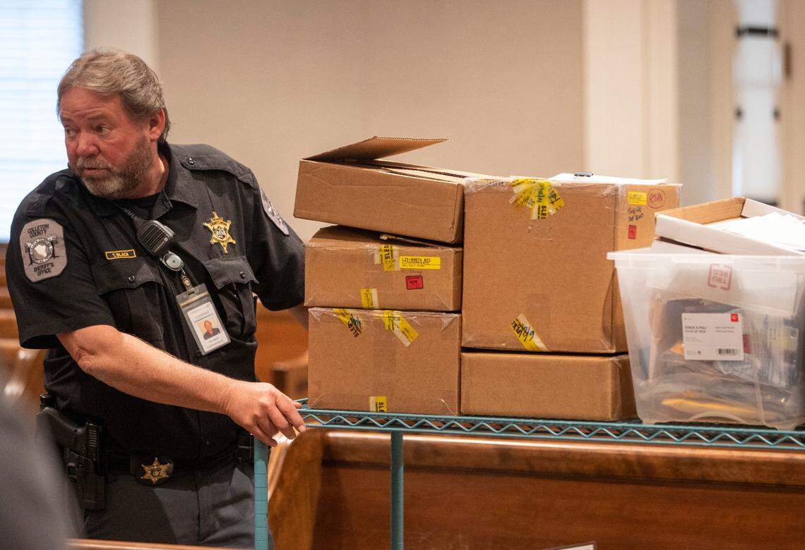 Courthouse deputy Tim Black carries off the evidence to the jury room for deliberation during the murder trial of Alex Murdaugh at the Colleton County Courthouse in Walterboro on Thursday, March 2, 2023. Andrew J. Whitaker/The Post and Courier/Pool
