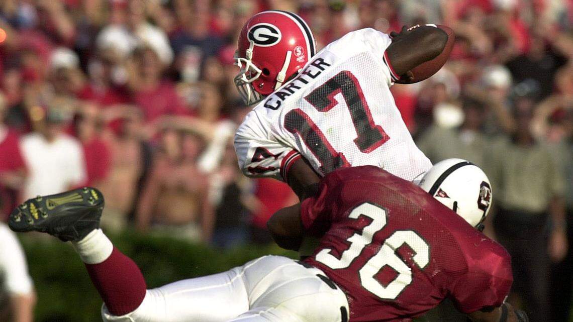 South Carolina’s Andre Offing tries to tackle Georgia quarterback Quincy Carter in the game where the Gamecocks upset the No. 9 ranked Georgia Bulldogs 21-10 on Sept. 9, 2000. UGA QB Quincy Carter was intercepted five times by the Gamecocks on the day.