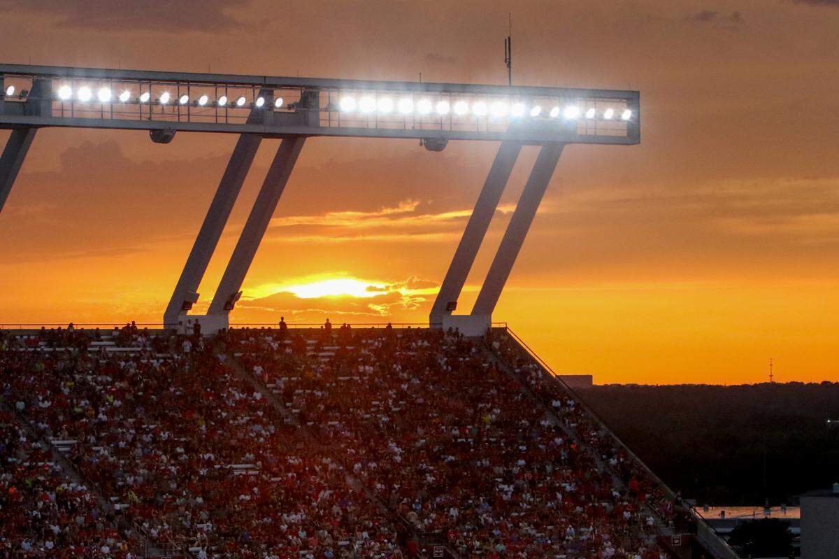 The sun sets over Williams-Brice Stadium as soccer fans watch the Premier League soccer match between Manchester United and Liverpool on Saturday, Aug. 3, 2024.