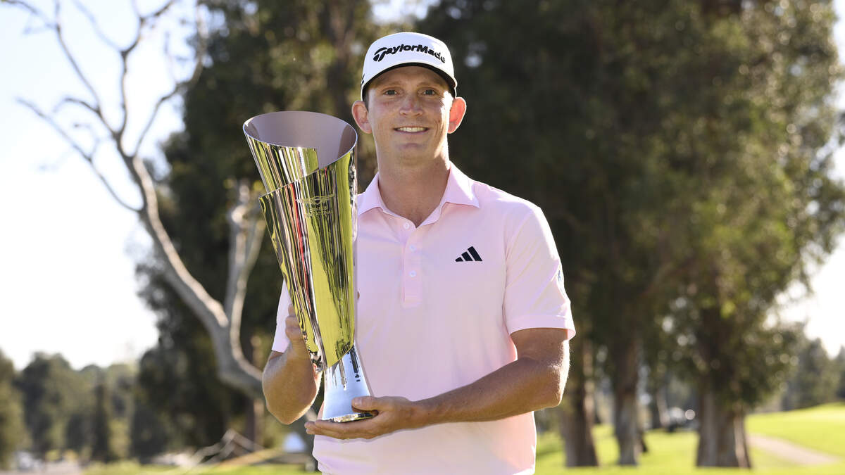 Jacob Bridgeman of the United States celebrates with the trophy on the 18th green after his win during the final round of The Genesis Invitational 2026 at Riviera Country Club on February 22, 2026 in Pacific Palisades, California.