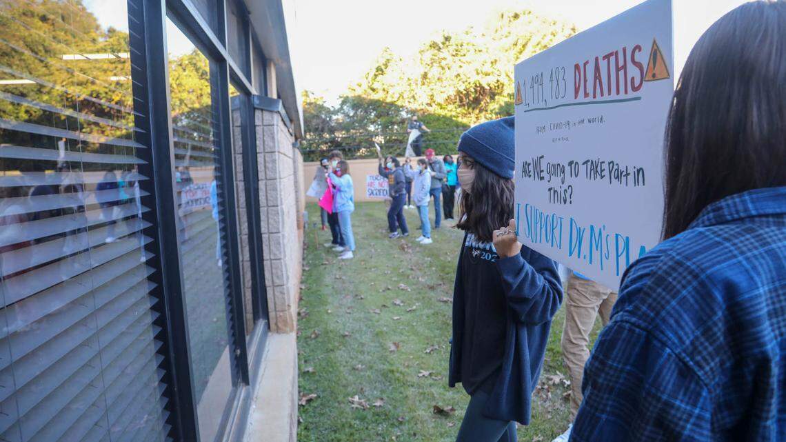 Students stand outside the Lexington-Richland District 5 office on Wednesday, Dec. 2, 2020 during a school board meeting, to express their opinion to take hybrid classes due to the coronavirus.