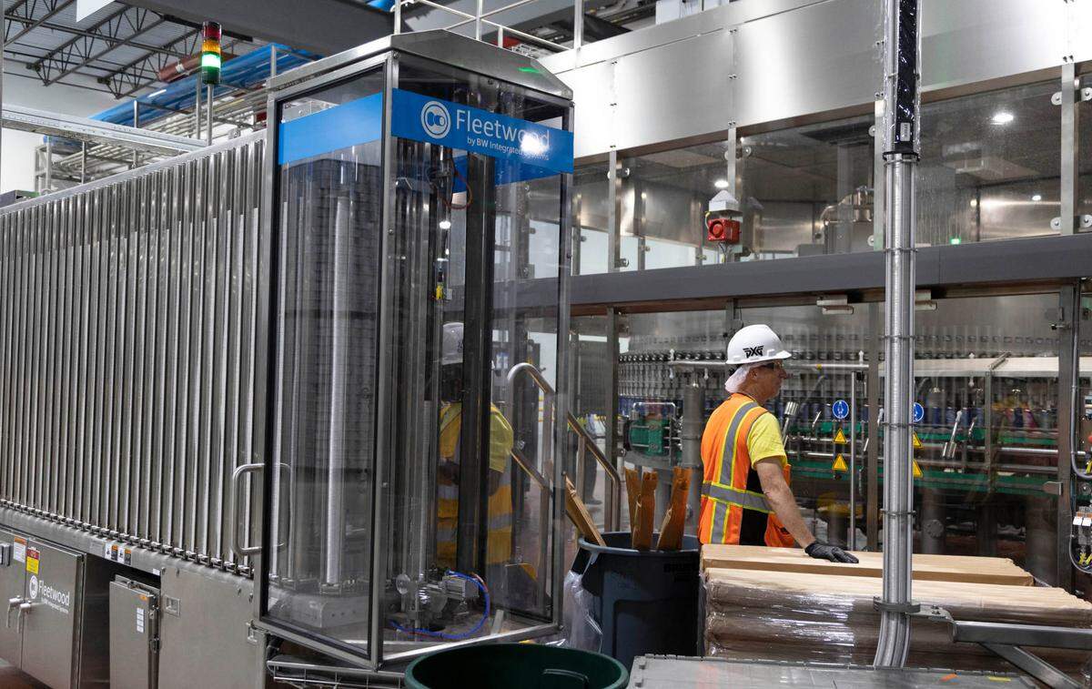Cans of Mike’s Harder malt beverage run through a filling line at the Mark Anthony Brewery in Columbia. The $490 million plant recently opened and has hired over 300 people.