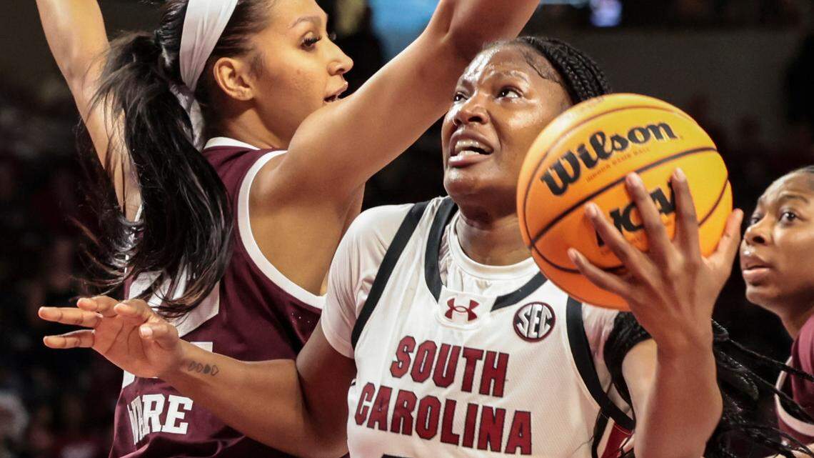 University of South Carolina’s Sania Feagin (20) drives between Texas A&M’s Lauren Ware (32) and Taliyah Parker (21) to shoot during the first half of action in the Colonial Life Arena on Thursday, Jan. 9, 2025.