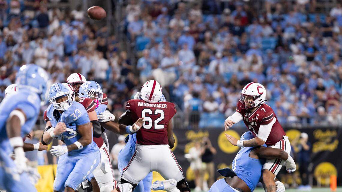 South Carolina quarterback Spencer Rattler (7) gets wrapped up while attempting a pass during the Gamecocks’ season opener against North Carolina at Bank of America Stadium in Charlotte on Saturday, September 2, 2023.