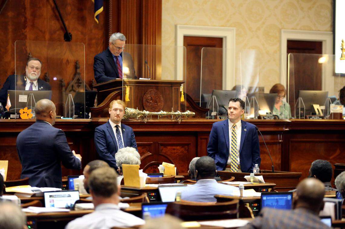 South Carolina Rep. Stewart Jones, right, R-Laurens, waits to answer a question from House Minority Leader Todd Rutherford, left, D-Columbia, during a debate on a bill that would ban employers from requiring COVID-19 vaccines for workers on Thursday, Dec. 9, 2021, in Columbia, S.C. The bill went from a subcommittee to the House floor during a special session in less than 48 hours. (AP Photo/Jeffrey Collins)