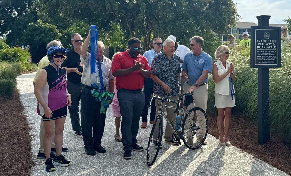 Frank Babel, third from right, stands between Mayor Alan Perry to his left and mayor pro tem Alex Brown after Town Council members and town staff participated in a ribbon cutting on Wednesday, July 30, 2025