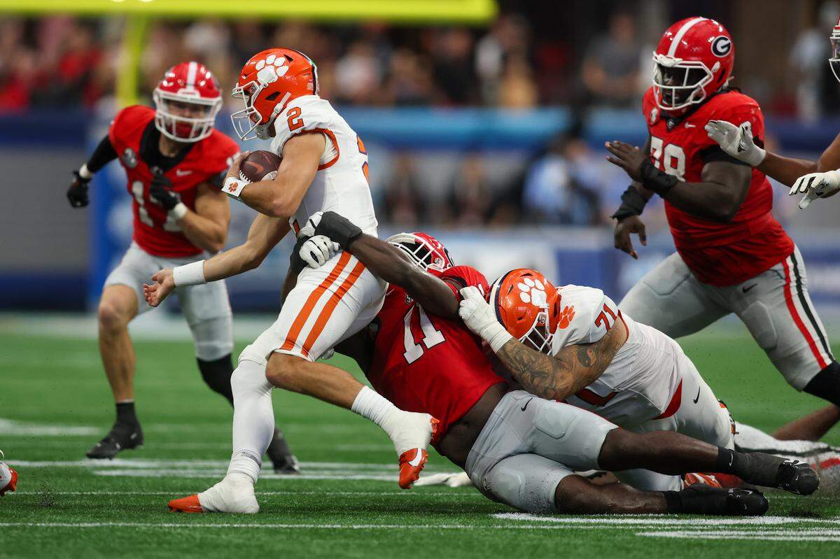 Clemson Tigers quarterback Cade Klubnik (2) is tackled by Georgia Bulldogs linebacker Jalon Walker (11) in the third quarter at Mercedes-Benz Stadium in Atlanta in 2024. Walker could be a contender for the Carolina Panthers with the No. 8 overall pick in Thursday’s NFL draft.