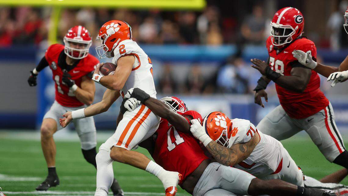 Clemson Tigers quarterback Cade Klubnik is tackled by Georgia Bulldogs linebacker Jalon Walker in the third quarter at Mercedes-Benz Stadium on Saturday, Aug. 31, 2024.