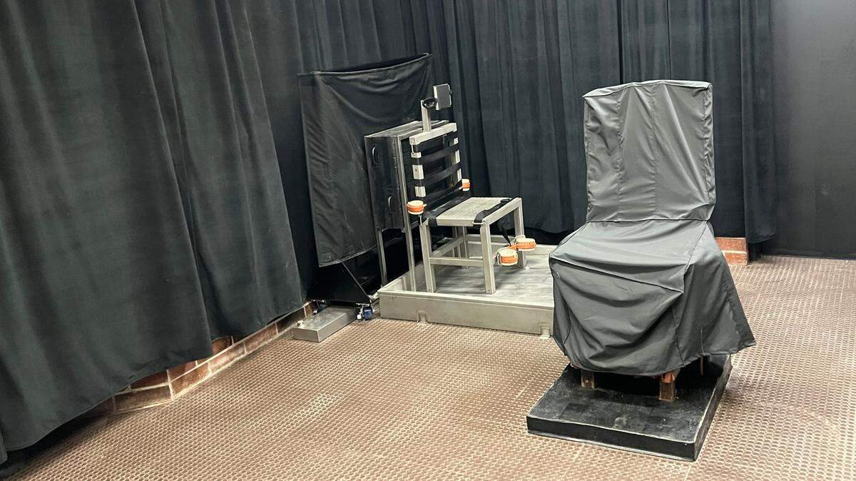 A photo of the South Carolina Department of Corrections’ renovated capital punishment facility as seen from the witness room at the agency’s Broad River Road complex in Columbia, S.C. The firing squad chair is shown on the left, uncovered. The covered chair is the electric chair, which does not move.