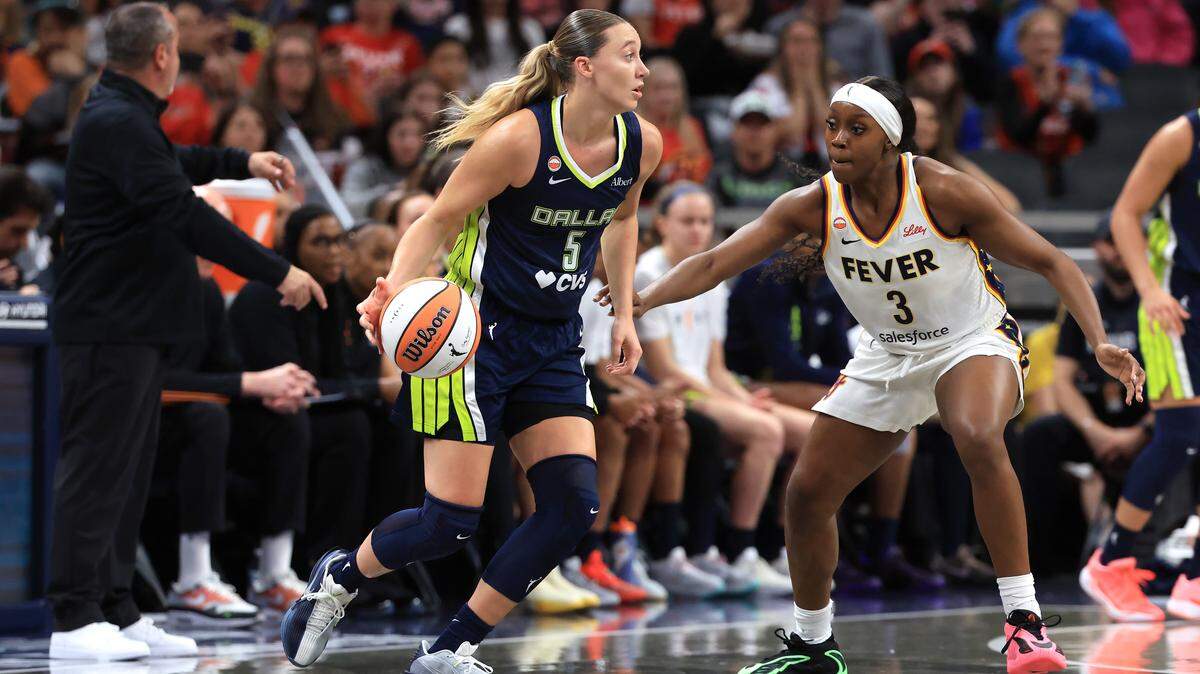 INDIANAPOLIS, INDIANA - APRIL 30: Paige Bueckers #5 of the Dallas Wings controls the ball against Raven Johnson #3 of the Indiana Fever during the first half of a preseason game at Gainbridge Fieldhouse on April 30, 2026 in Indianapolis, Indiana.