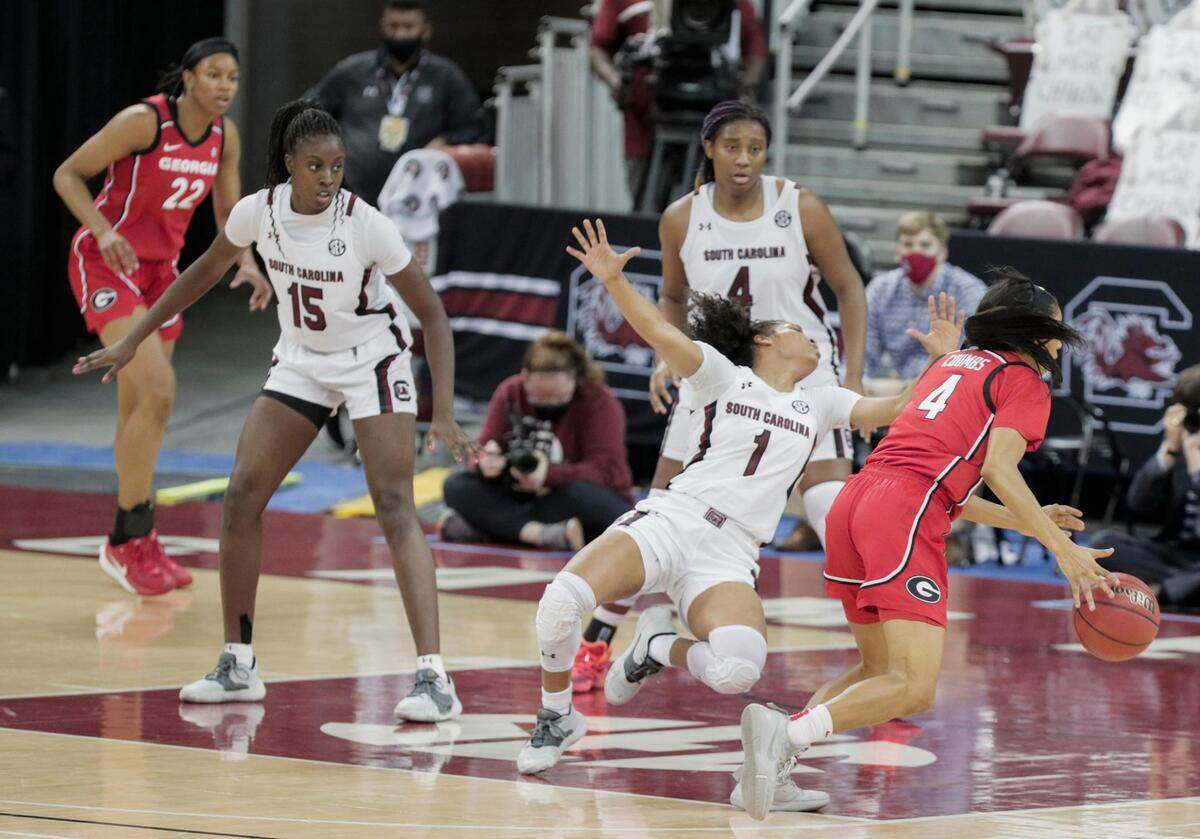 South Carolina Gamecocks guard Zia Cooke (1) falls as Georgia Lady Bulldogs guard Mikayla Coombs (4) moves into position to shoot at Colonial Life Arena on Thursday, January 21, 2021.