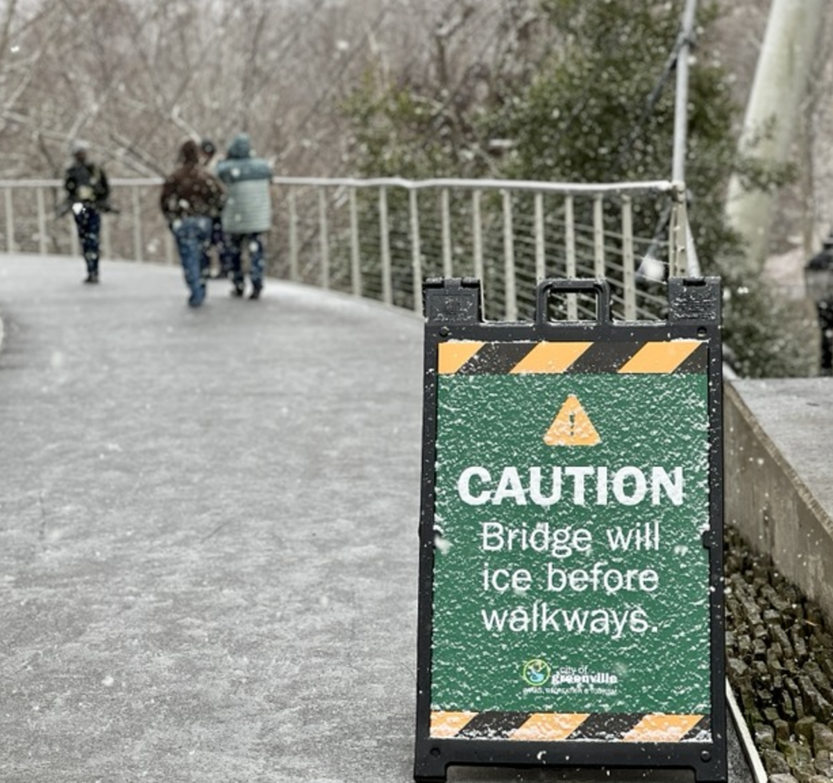 Residents take a walk on Liberty Bridge across the Reedy River in downtown Greenville Friday Jan. 10, 2025.