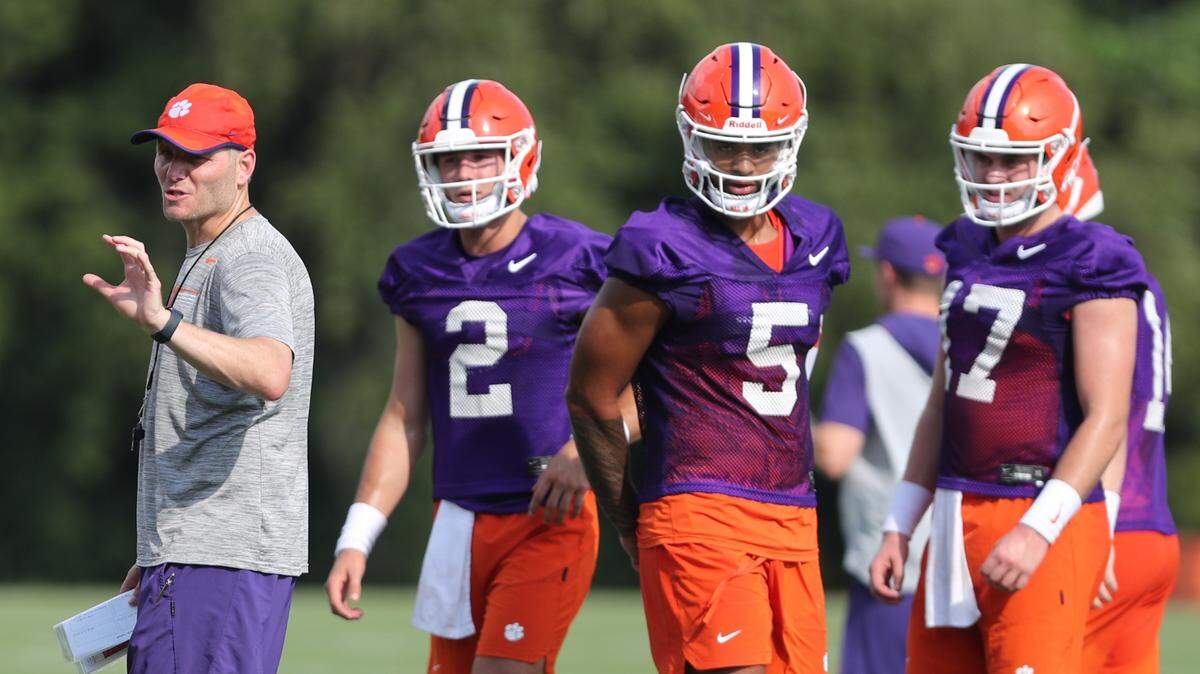 Clemson football offensive coordinator Brandon Streeter (left) with quarterbacks Cade Klubnik (2) and DJ Uiagalelei (5) at the Tigers’ opening day of preseason camp on Friday, Aug. 5, 2022.