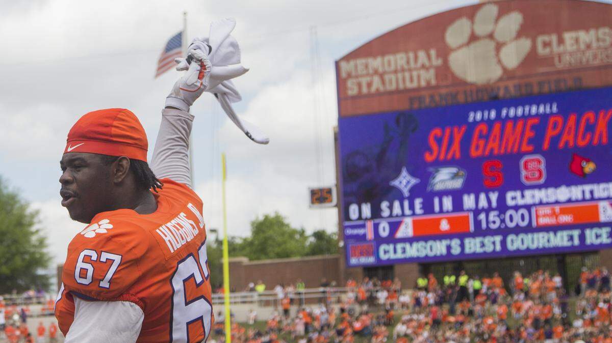 Clemson defensive end Albert Huggins waves a towel in the air at the start of the Clemson spring game at Memorial Stadium on Saturday April 14, 2018, in Clemson, SC.