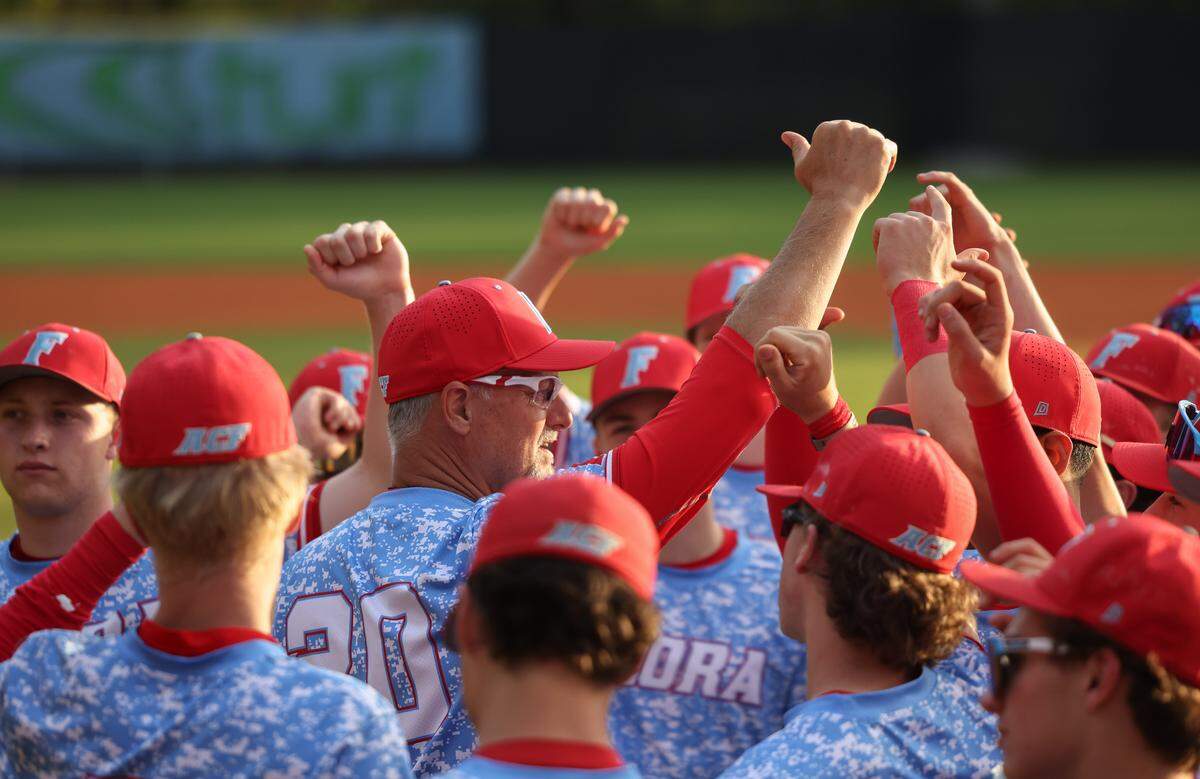 AC Flora head coach Andy Hallett huddles with his team during AC Flora’s game against South Pointe in Columbia in March.