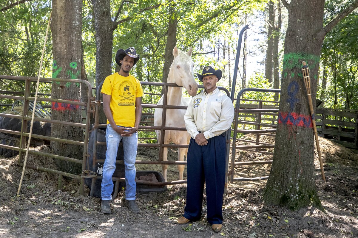 Ivory Johnson, founder of the Junior Buffalo Soldiers Leadership Academy, and Taylon Holmes, public relations director, stand beside Zulu, a 15-year-old Tennessee Walker, on Johnson’s ranch in Arthurtown, a historically black neighborhood in Columbia, SC. The leadership academy allows children who wouldn’t be able to afford to go horse riding a chance to become cowboy themselves. Johnson founded the academy while attending the Black Cowboy “Man or Myth” African-American Cultural Festival.