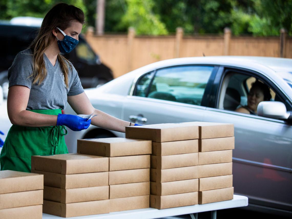 Sarah Brownson hand outs cookies, muffins and other baked goods ordered online from Silver Spoon Bake Shop on Friday, April 17, 2020. Online orders have sold out in as little as ten minutes since the bakery has moved to once a week pick up.