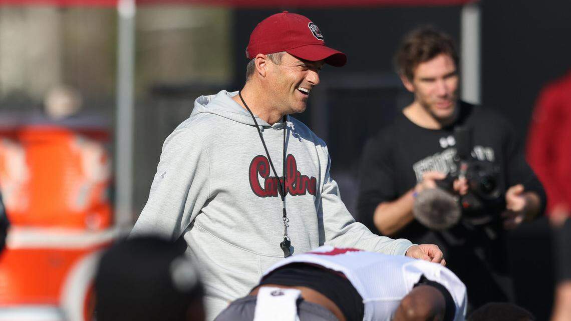 South Carolina head coach Shane Beamer laughs with players during the Gamecocks’ first day of spring practice in Columbia on Wednesday, March 19, 2025.