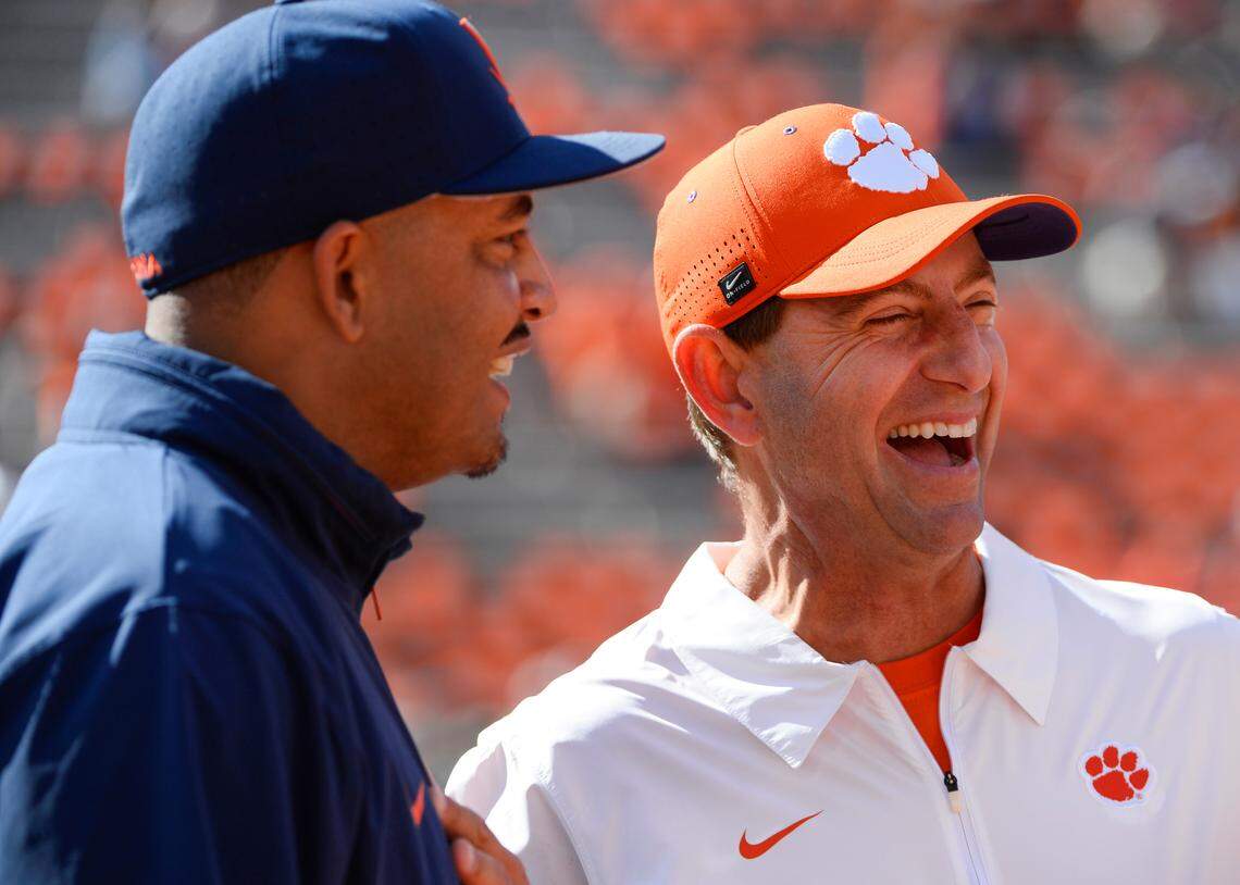 Oct 19, 2024; Clemson, South Carolina, USA; Virginia Cavaliers Head Coach Tony Elliott interacts with Clemson Tigers head coach Dabo Swinney prior to the game at Memorial Stadium.