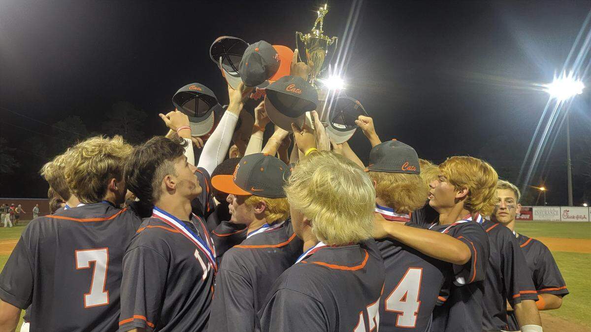 Laurence Manning players celebrate with the championship trophy after defeating Ben Lippen to win the 2022 SCISA 3A baseball championship on May 19, 2022, in Sumter.