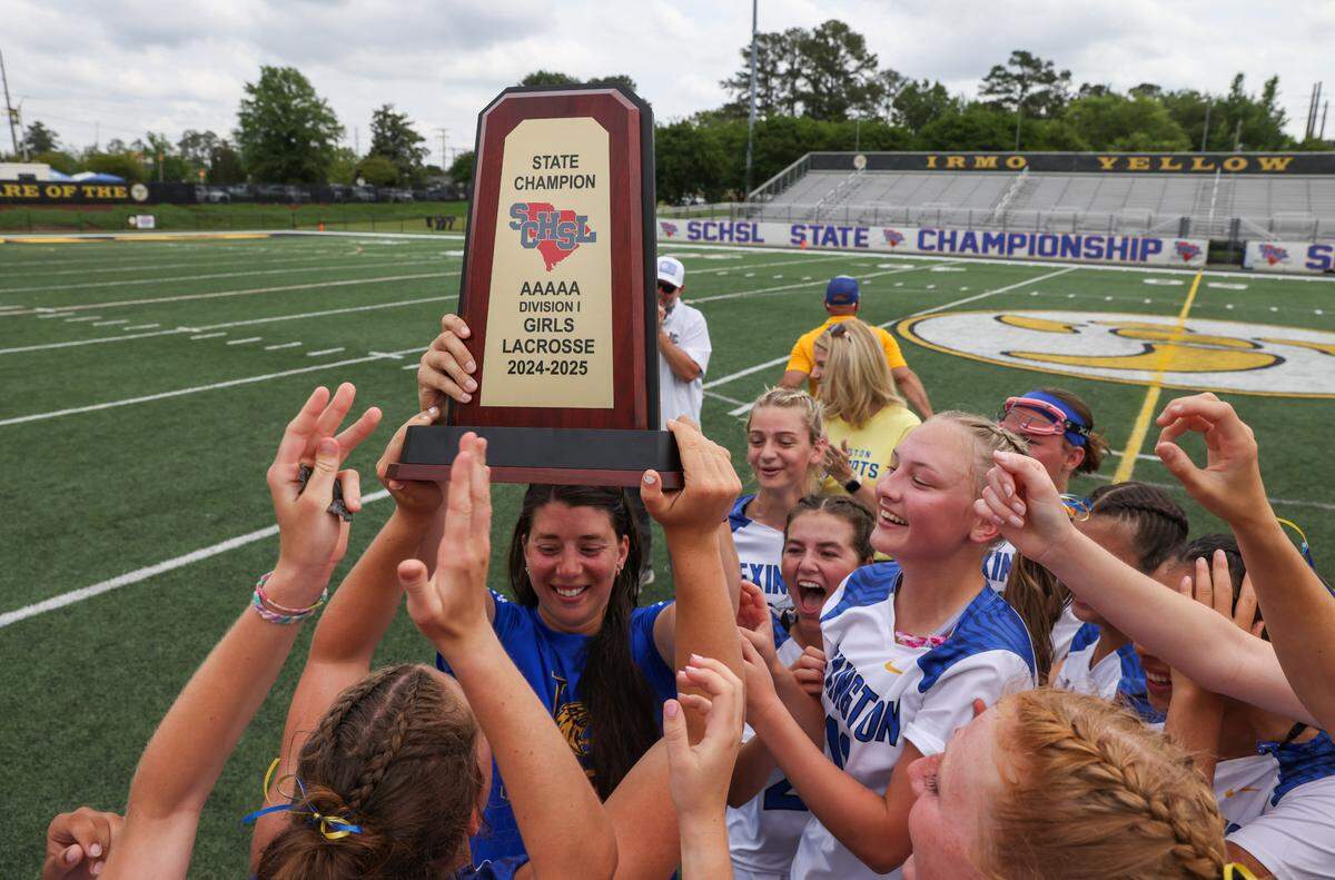 Lexington players celebrate with head coach Tiffany Tortorello following the SCHSL Class 5A Division I Girls Lacrosse State Championships at Irmo High School on Saturday, May 3, 2025.