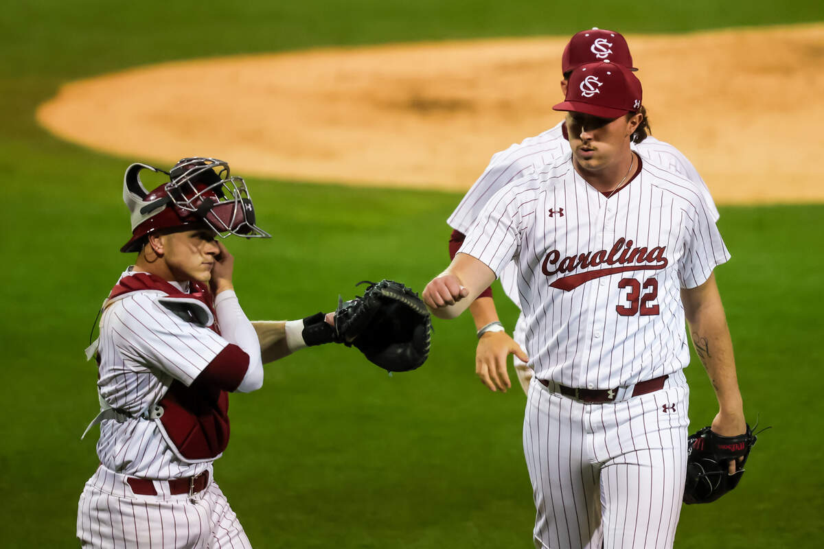 South Carolina Gamecocks pitcher Brandon Stone (32) high fives catcher Ryan Bakes (21) after getting out of an inning against the Morehead State Eagles during their game at Founders Park, 3/7/25.