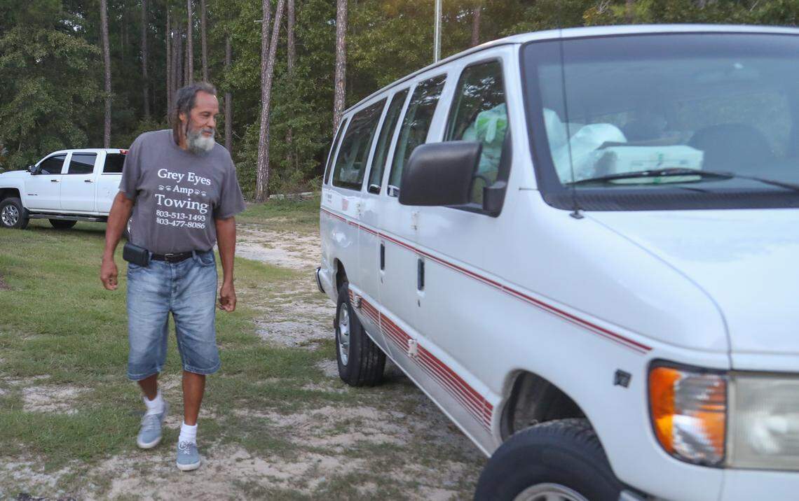 James Sanders, who is know widely as Uncle James, admires the van that is used by his neighborhood to help children. Village Church in Blythewood facilitated and funded the repair of the van. 