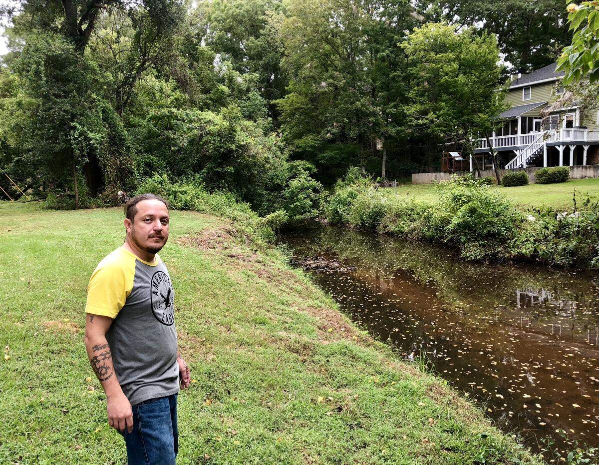 Karim Ramos looks onto Rawls Creek, which flooded his neighborhood in 2015 before he lived there. He said he’s nervous it could flood again if Hurricane Florence lingers in the Columbia area.
