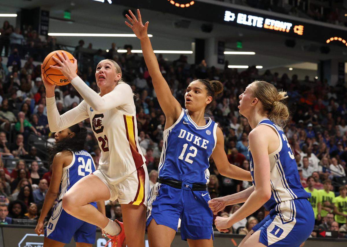 University of South Carolina’s Chloe Kitts (21) shoots as Duke’s Delaney Thomas (12) pressures during the second half of action at the Legacy Arena in Birmingham on Sunday, March 30, 2025 in the Birmingham 2 regional of the NCAA Tournament.