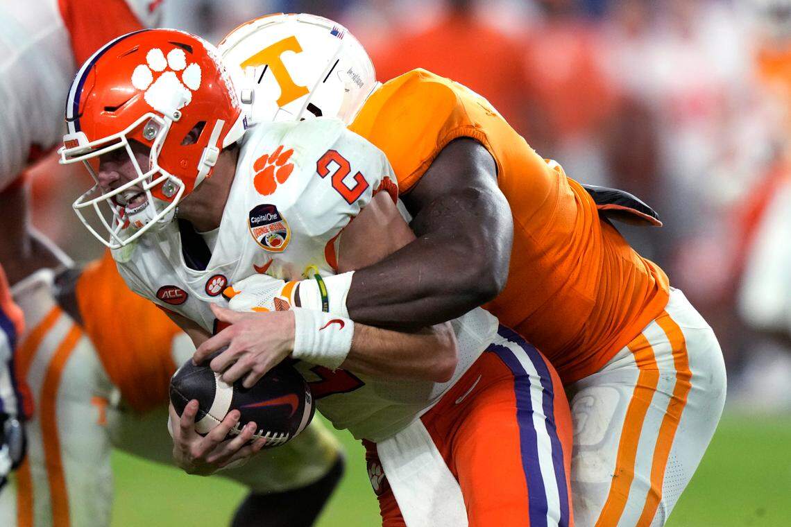 Clemson quarterback Cade Klubnik (2) is tackled by Tennessee defensive lineman Byron Young during the second half of the Orange Bowl NCAA college football game Friday, Dec. 30, 2022, in Miami Gardens, Fla. (AP Photo/Lynne Sladky)