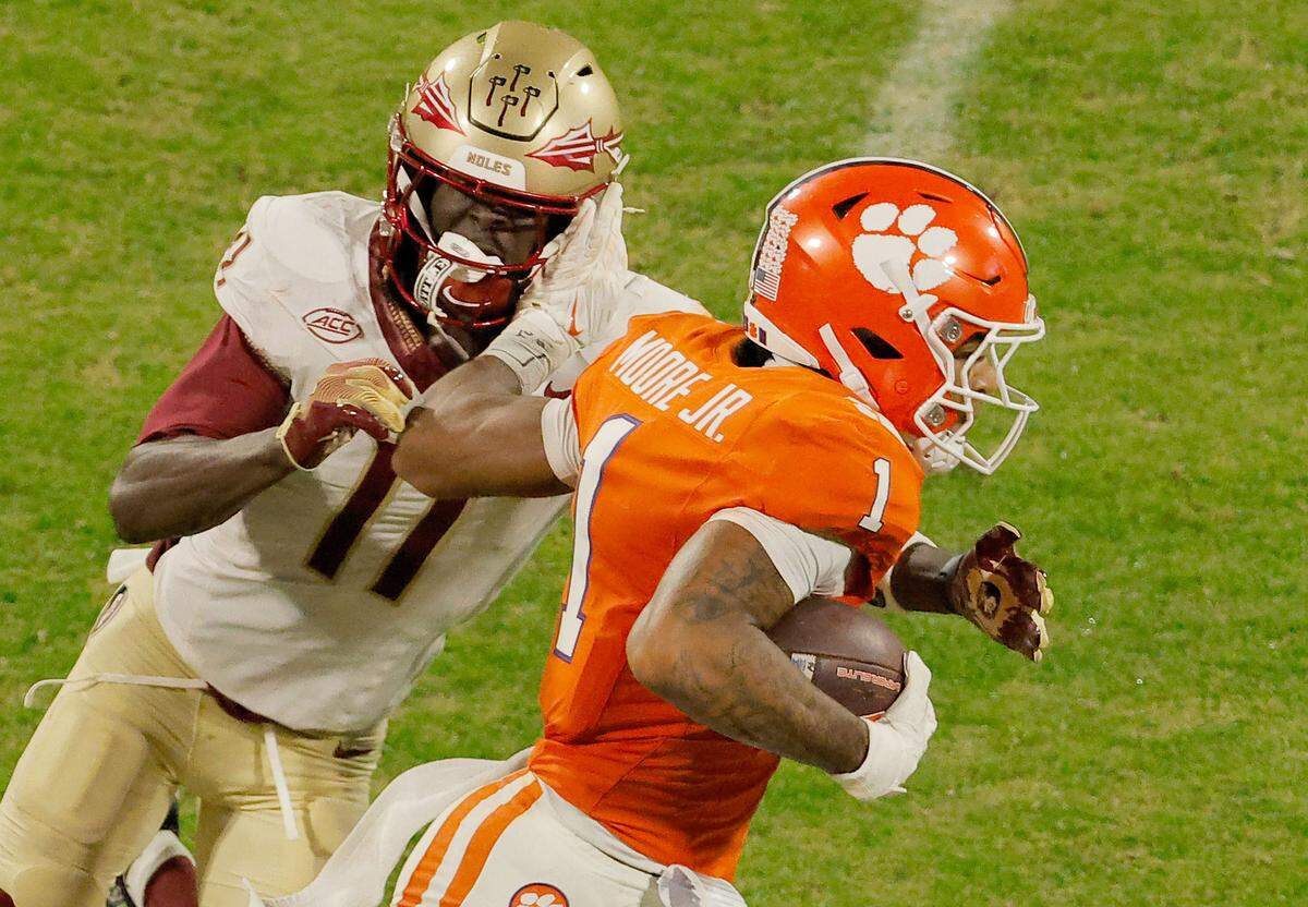 Clemson wide receiver T.J. Moore (1) pushes Florida State defensive back Ja'Bril Rawls (11) aside during first-half action in Clemson, S.C. on Saturday, Nov. 8, 2025.