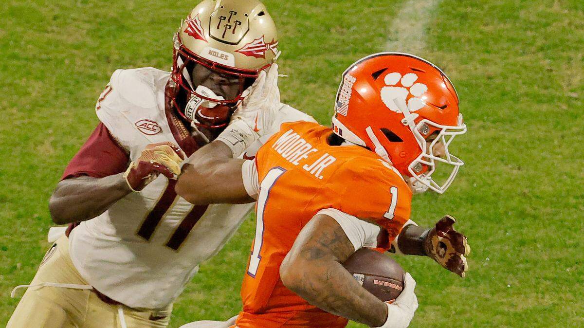Clemson wide receiver T.J. Moore (1) pushes Florida State defensive back Ja'Bril Rawls (11) aside during first-half action in Clemson, S.C. on Saturday, Nov. 8, 2025.