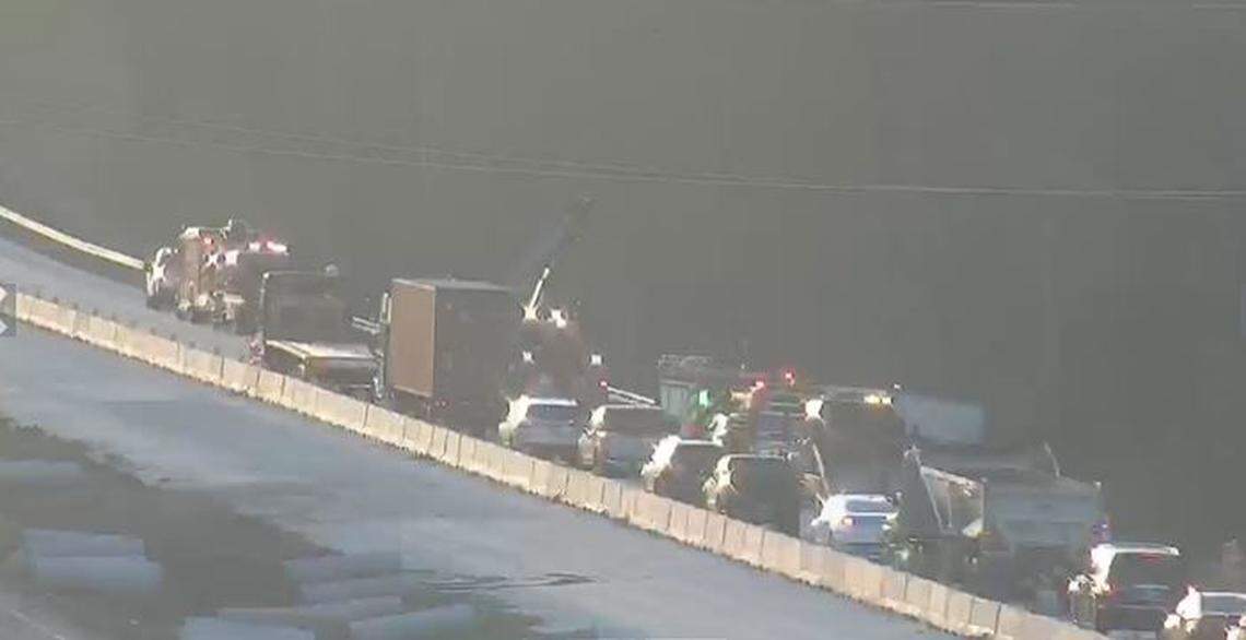 Vehicles were backed up on an interstate after a crash and hazardous material spill.